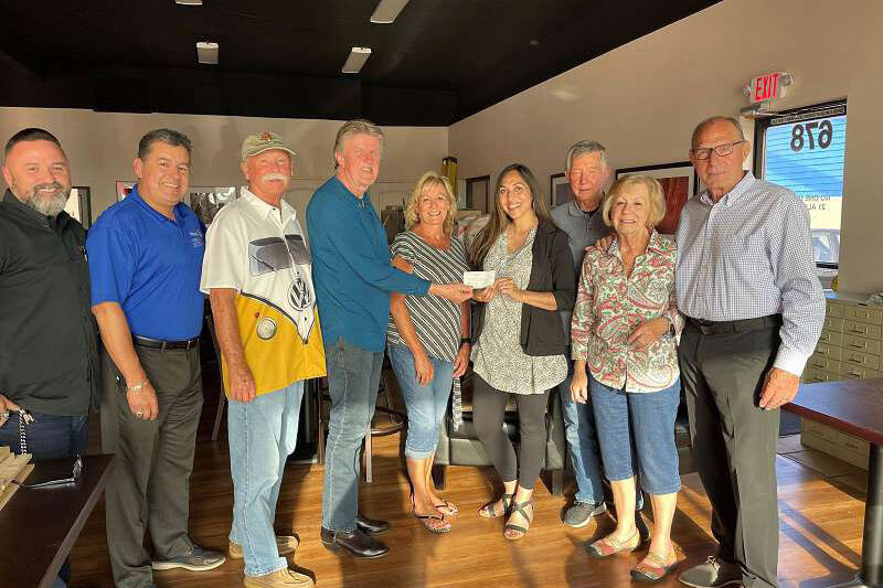 John Espinoza taking a group picture with members of the Sunrise Rotary of Covina, California giving a donation check to a charity.