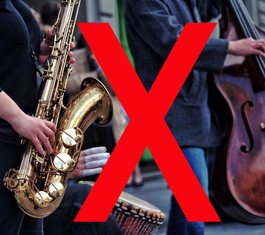 Jazz band man playing the saxophone and another man play the cello shown from the waist down only.